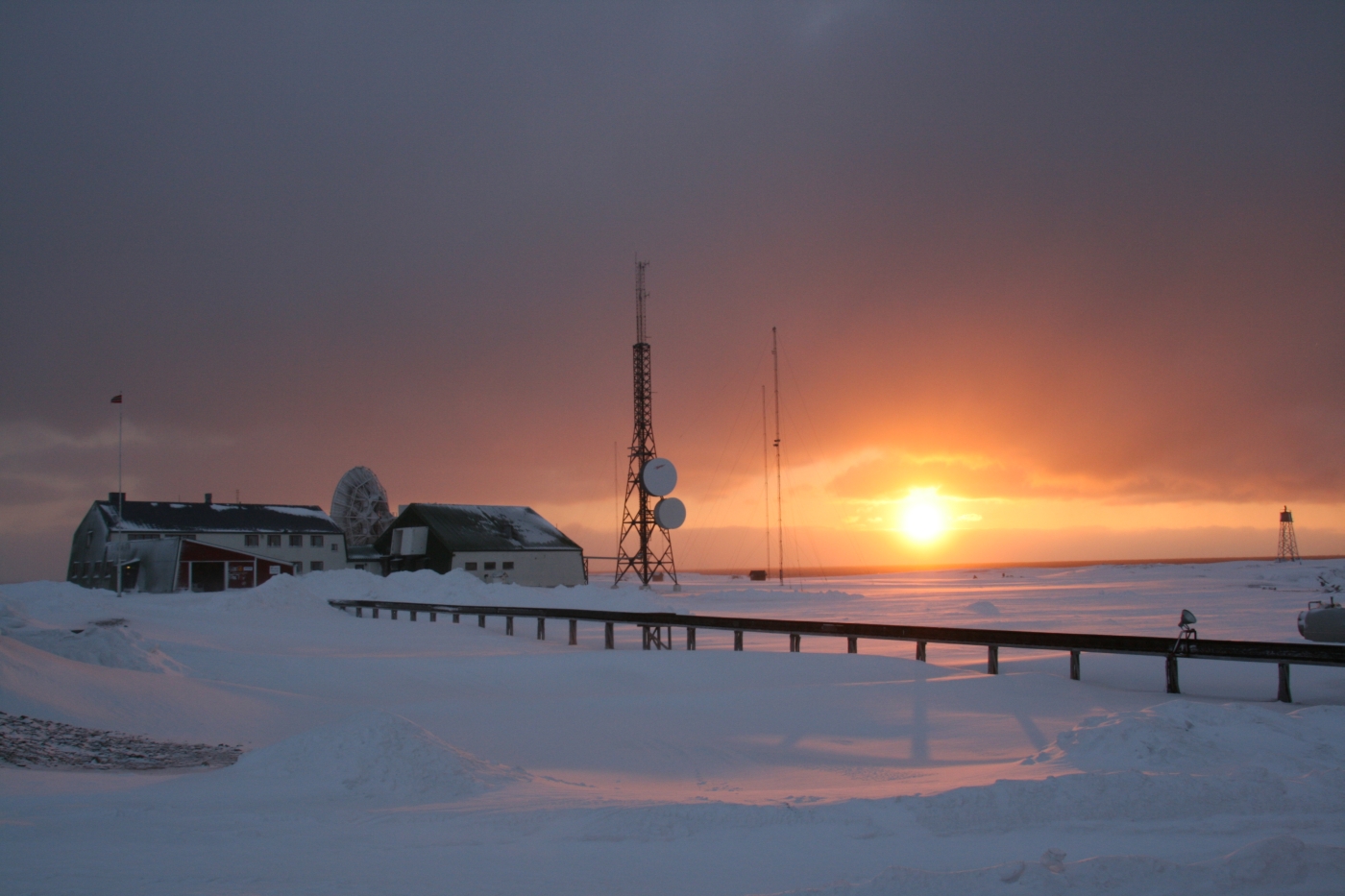 Exterior view with sun at Basecamp Explorer - Isfjord Radio Adventure Hotel in Svalbard Norway