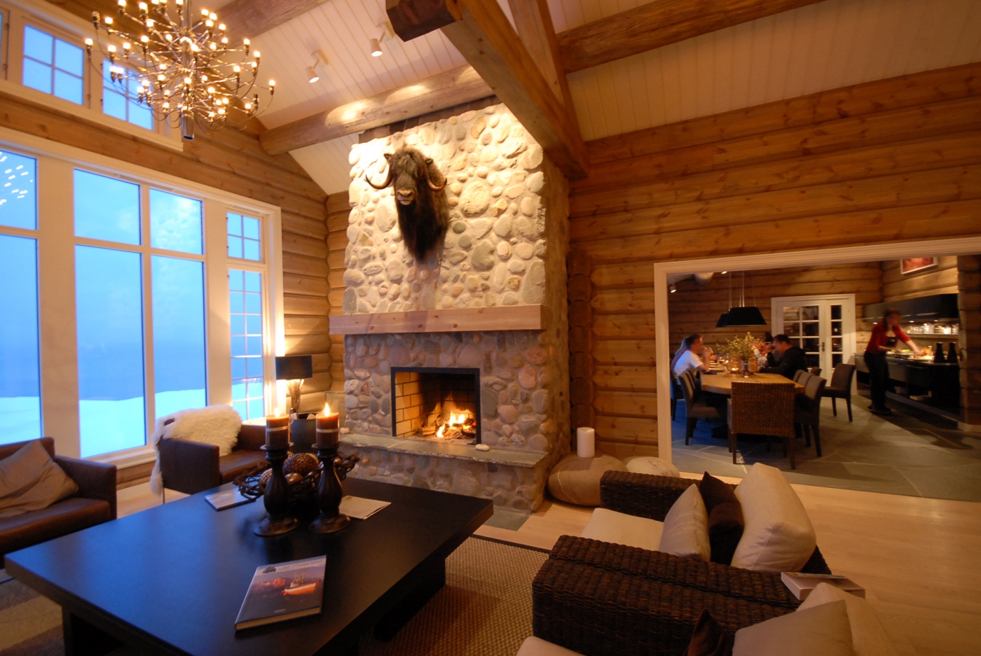 Cosy lounge area with fireplace at Lyngen Lodge in Norway