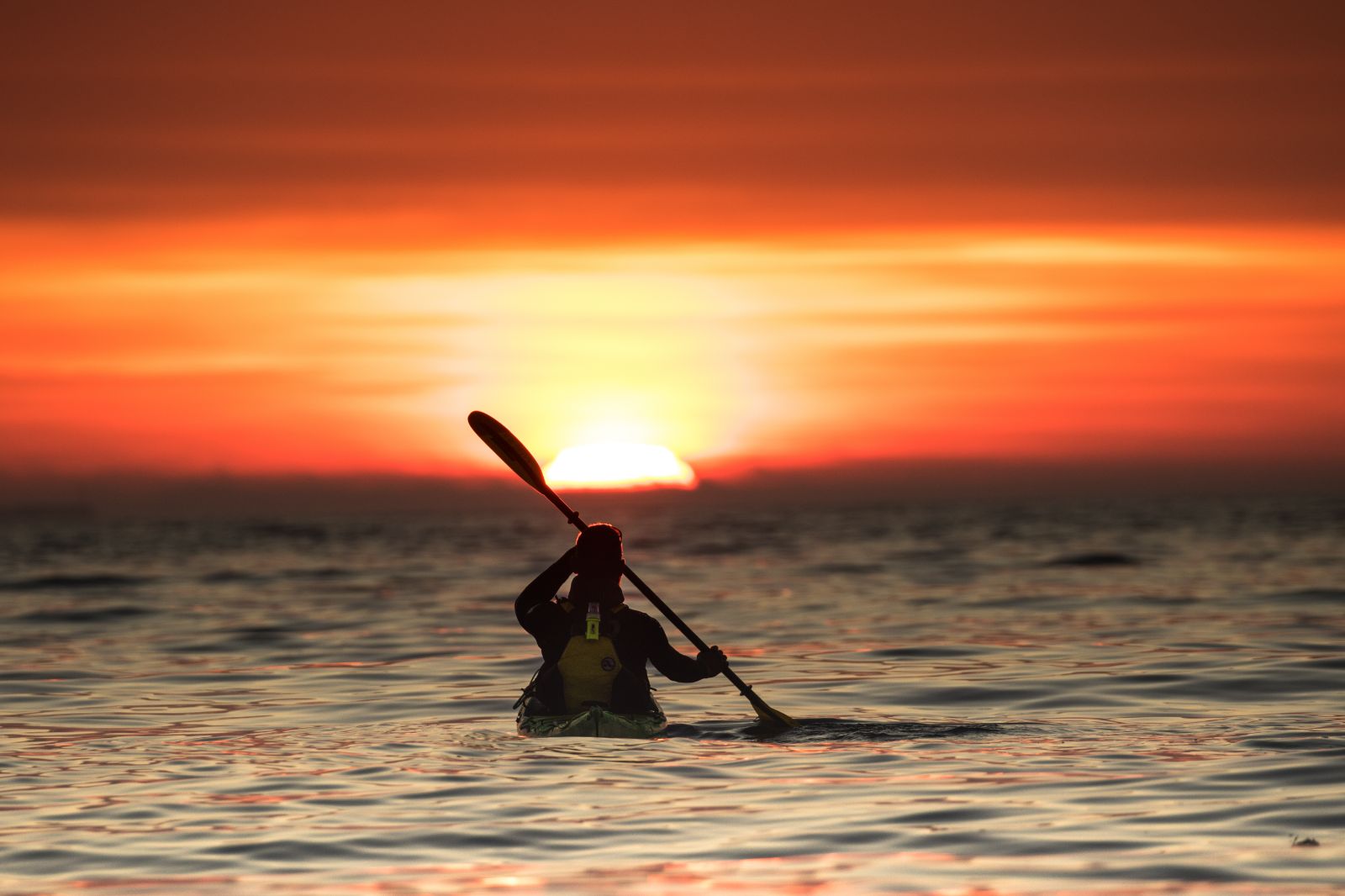 Kayaking at sunset on the grounds of Nusfjord Arctic Resort in Norway