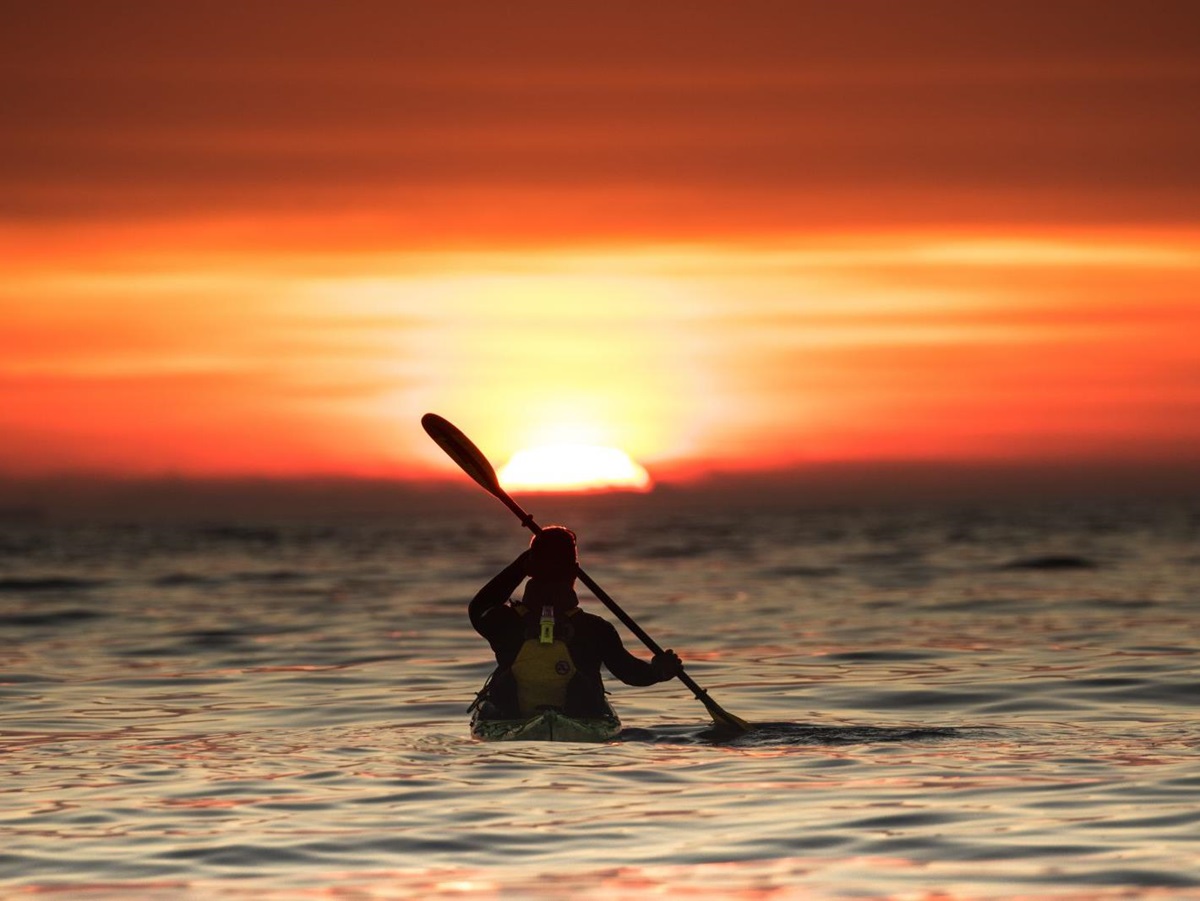 Kayaking at sunset on the grounds of Nusfjord Arctic Resort in Norway