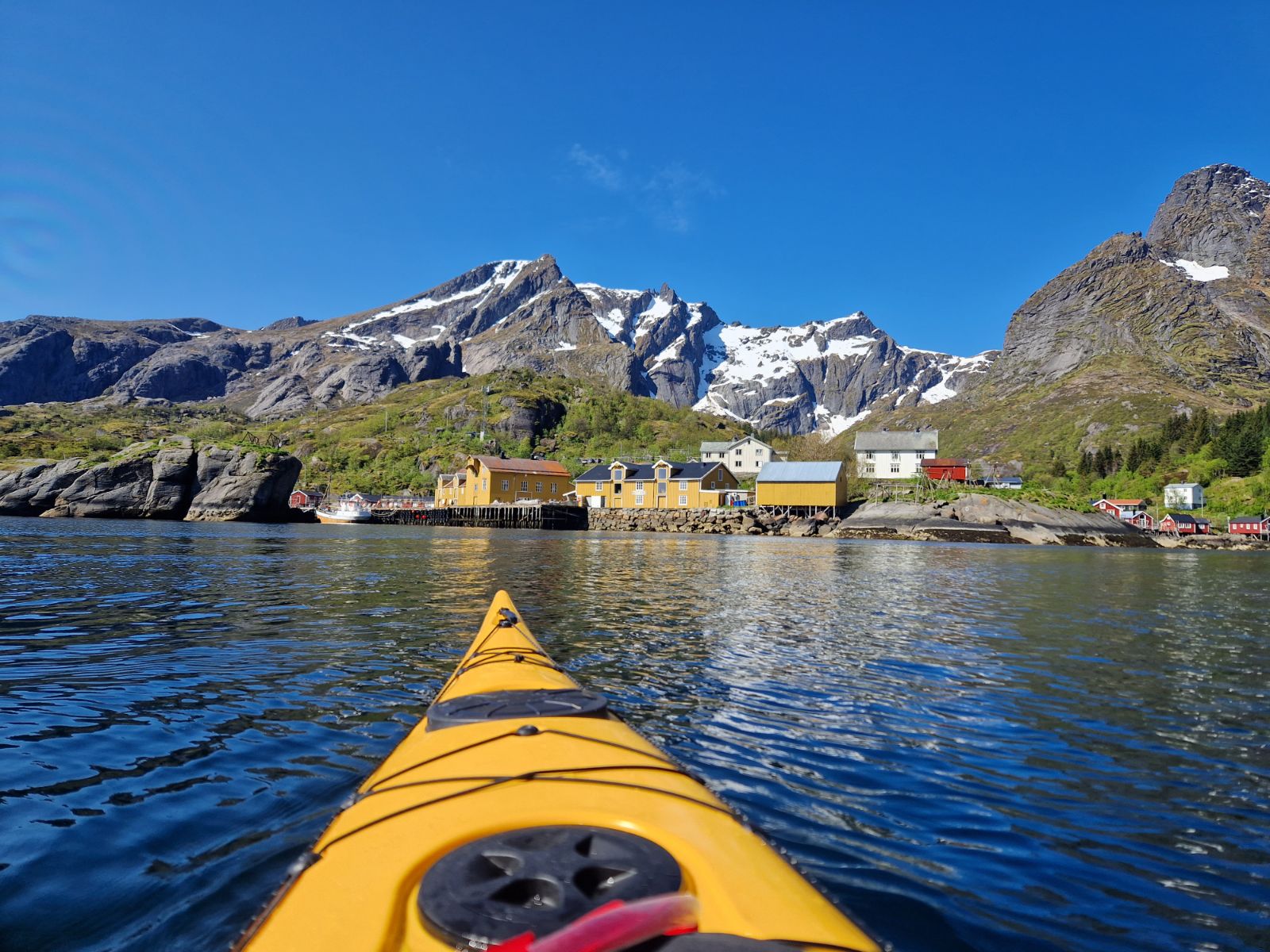 Kayaking on the waters surrounding Nusfjord Arctic Resort in Norway