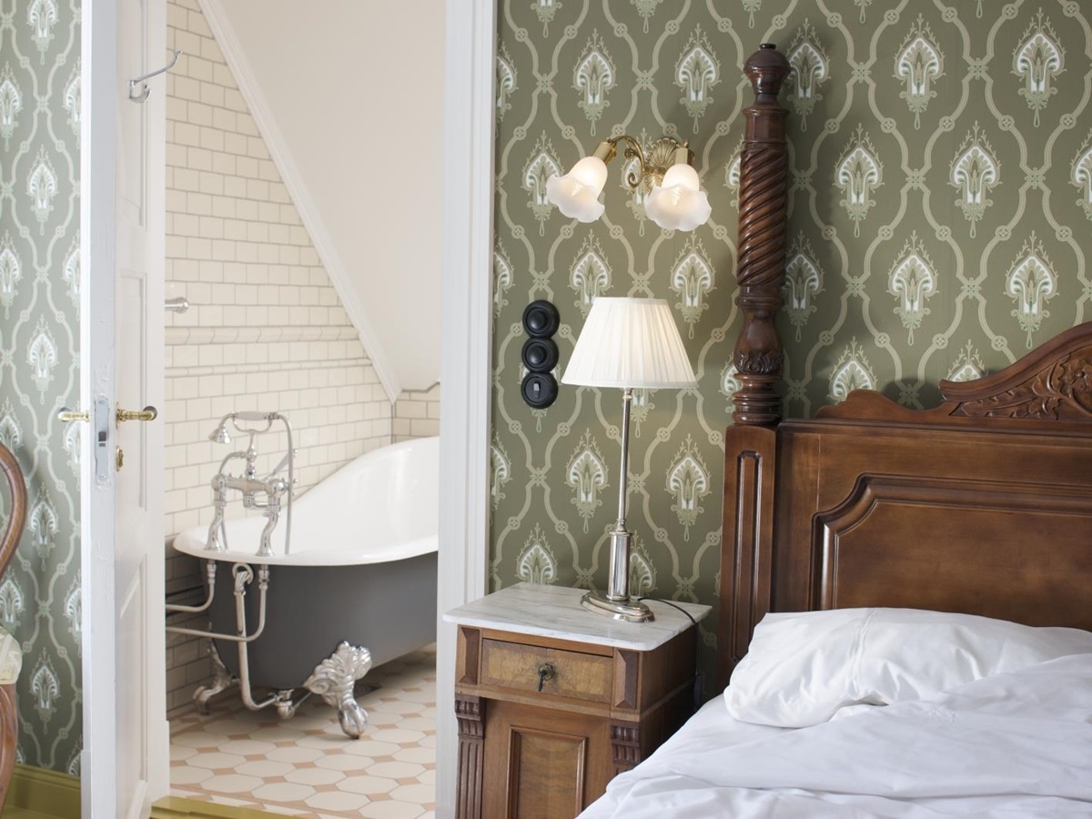 Room and bathroom view in main building of Walaker Hotel in Norway