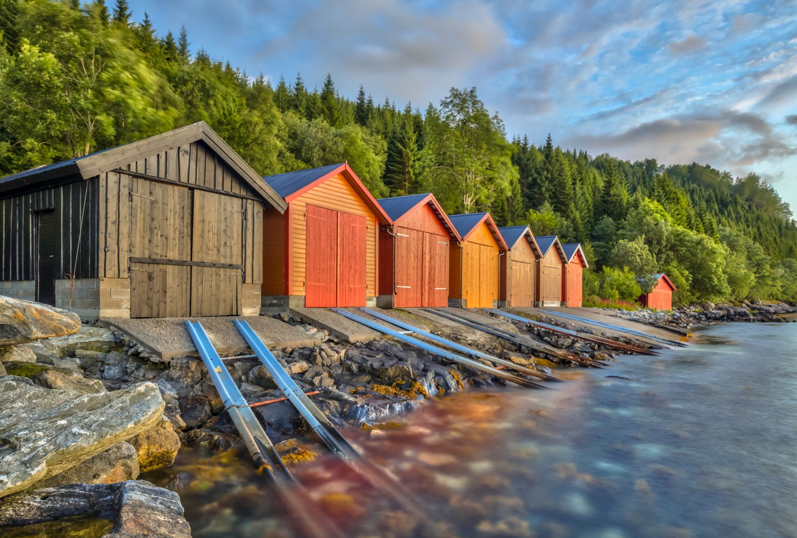 Colourful boat houses on the waters edge in Romsdalfjord Norway