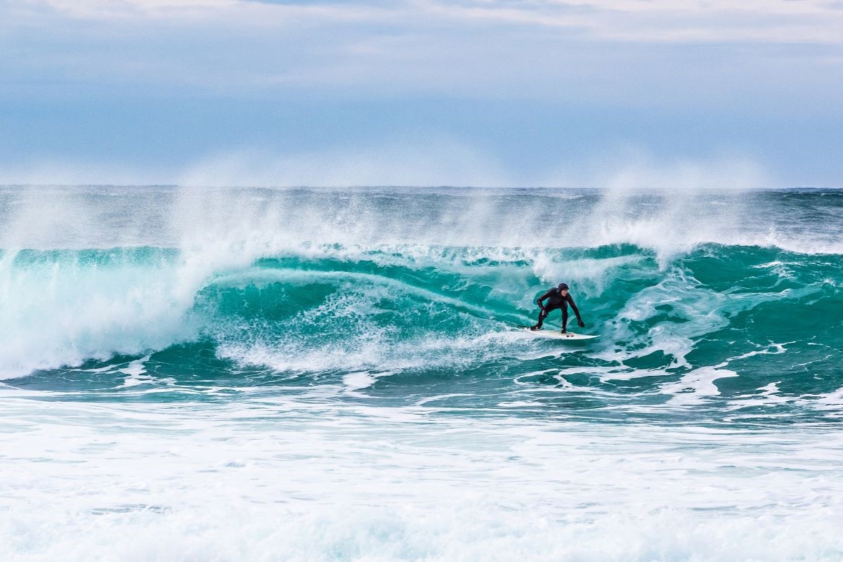 A man surfing in the Lofoten Islands (Credit: Alex Conu - VisitNorway)