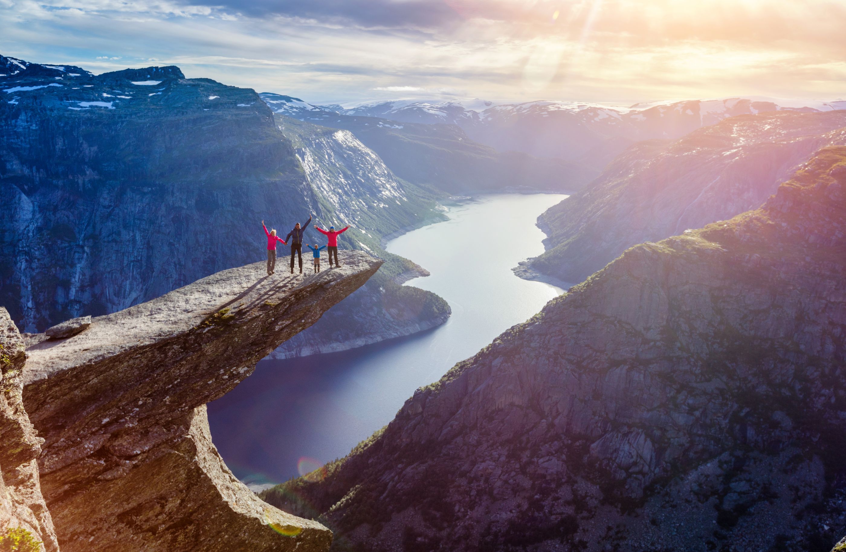 Family admiring views from the outcrop at Trolltunga, Norway