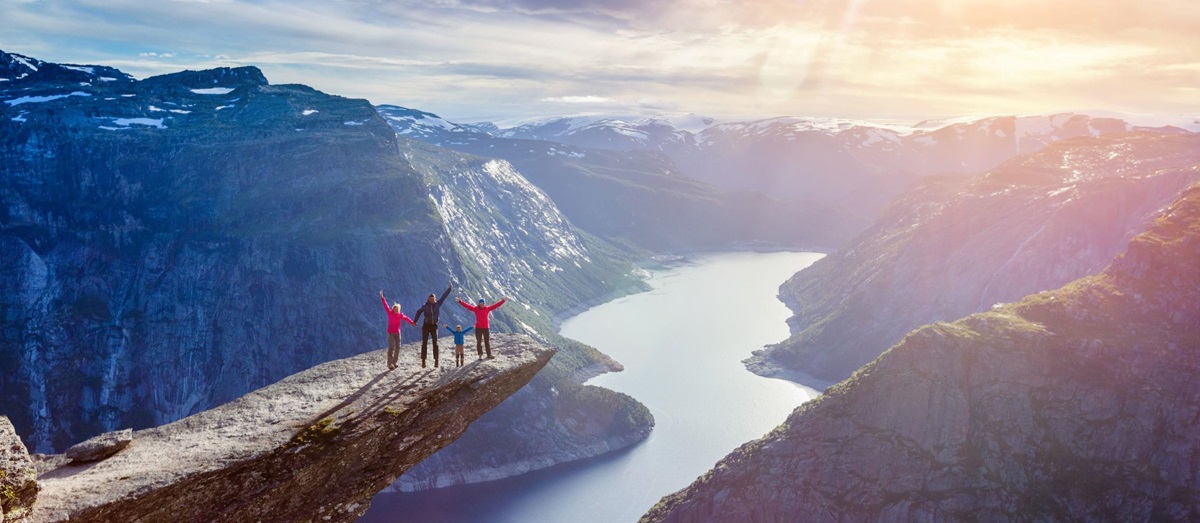 Family admiring views from the outcrop at Trolltunga, Norway