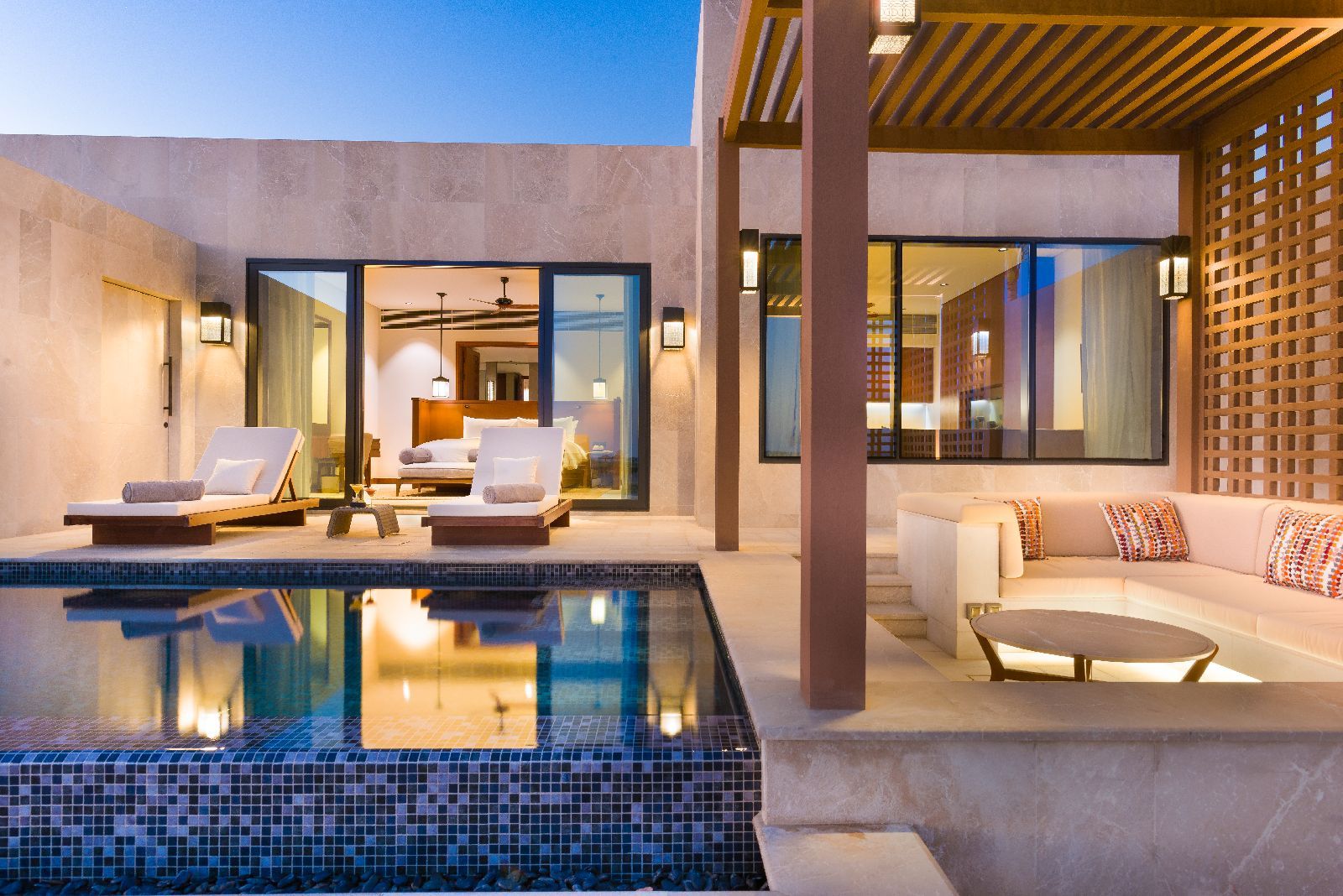 A pool villa at Alila Hinu Bay Oman illuminated by night