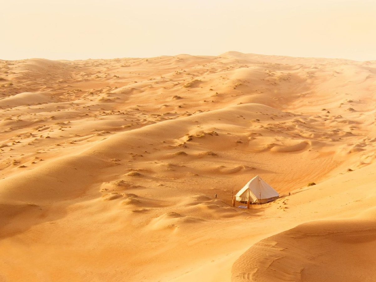 Distant view of the Canvas Club tented camp in the middle of the Oman desert