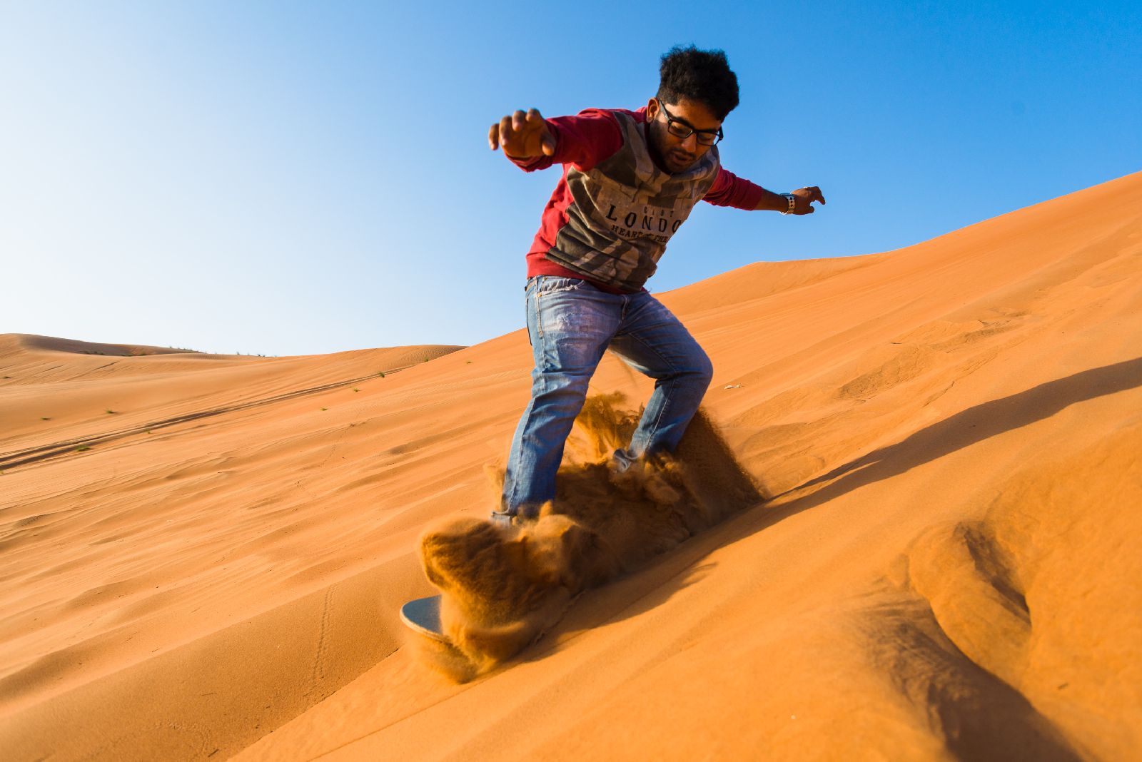 Sand boarding from Desert Nights Camp Oman