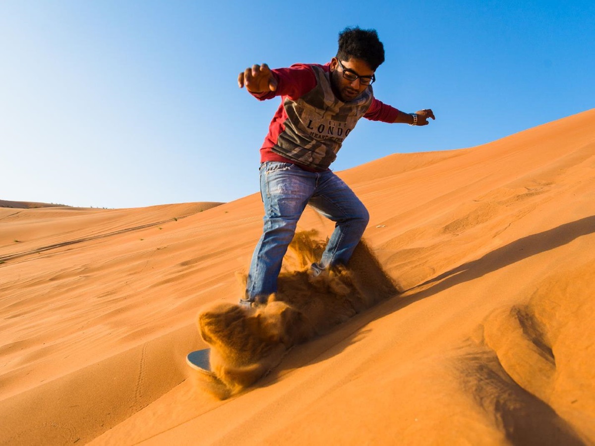 Sand boarding from Desert Nights Camp Oman