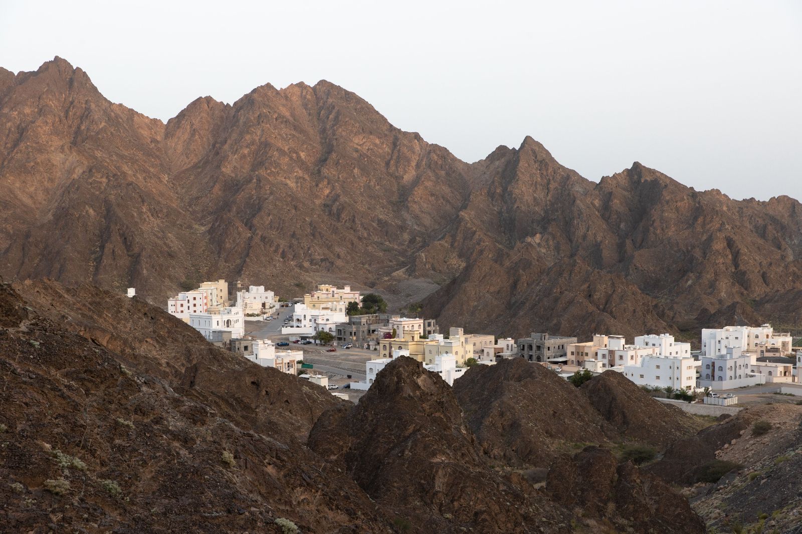 Distant view of the Jumeirah Muscat Bay in Oman surrounded by mountains