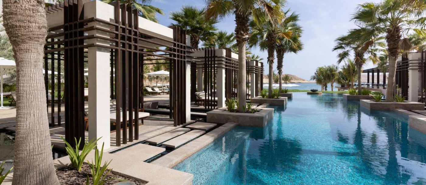Huts by the poolside at Jumeirah Muscat Bay in Oman