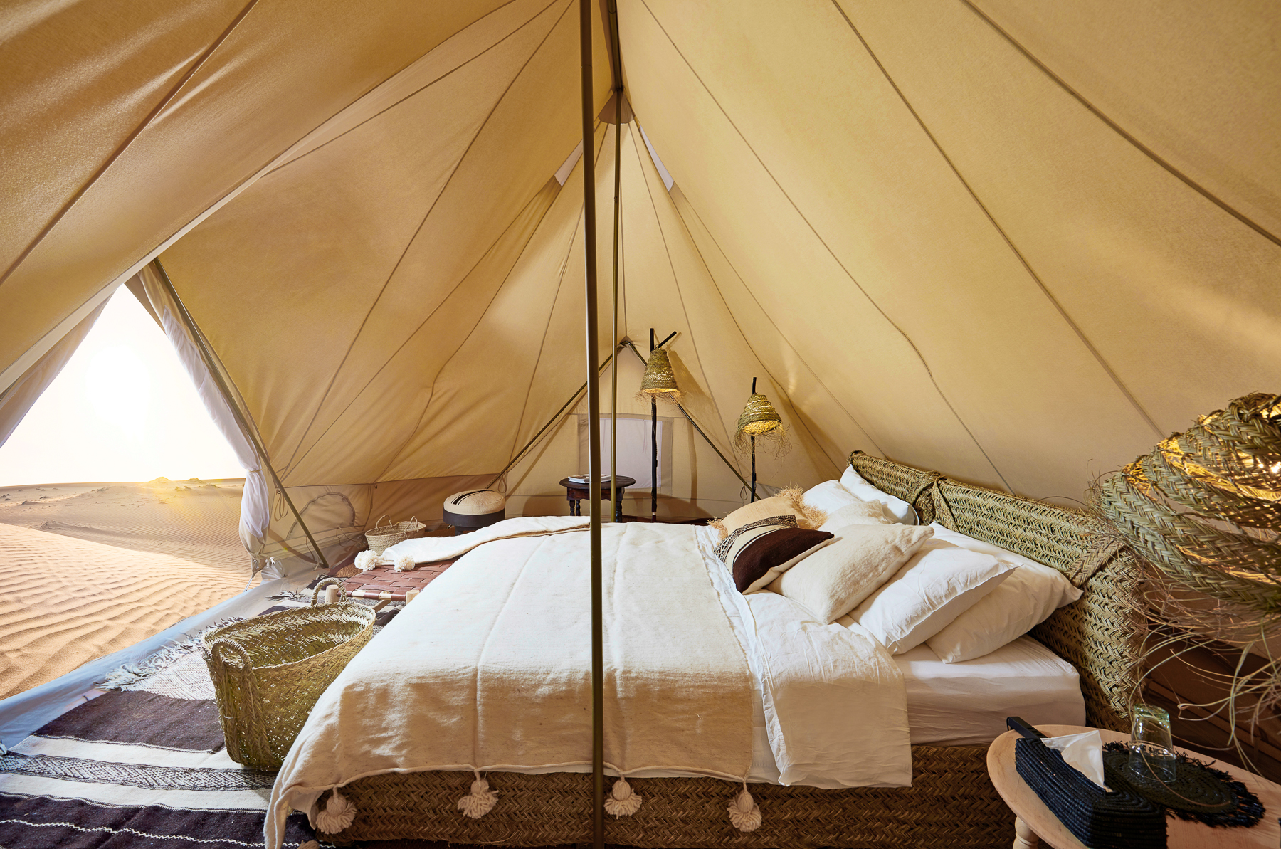 Bed in a guest tent at Magic Camps Wahiba Sands in the Sharqiya Sands in Oman