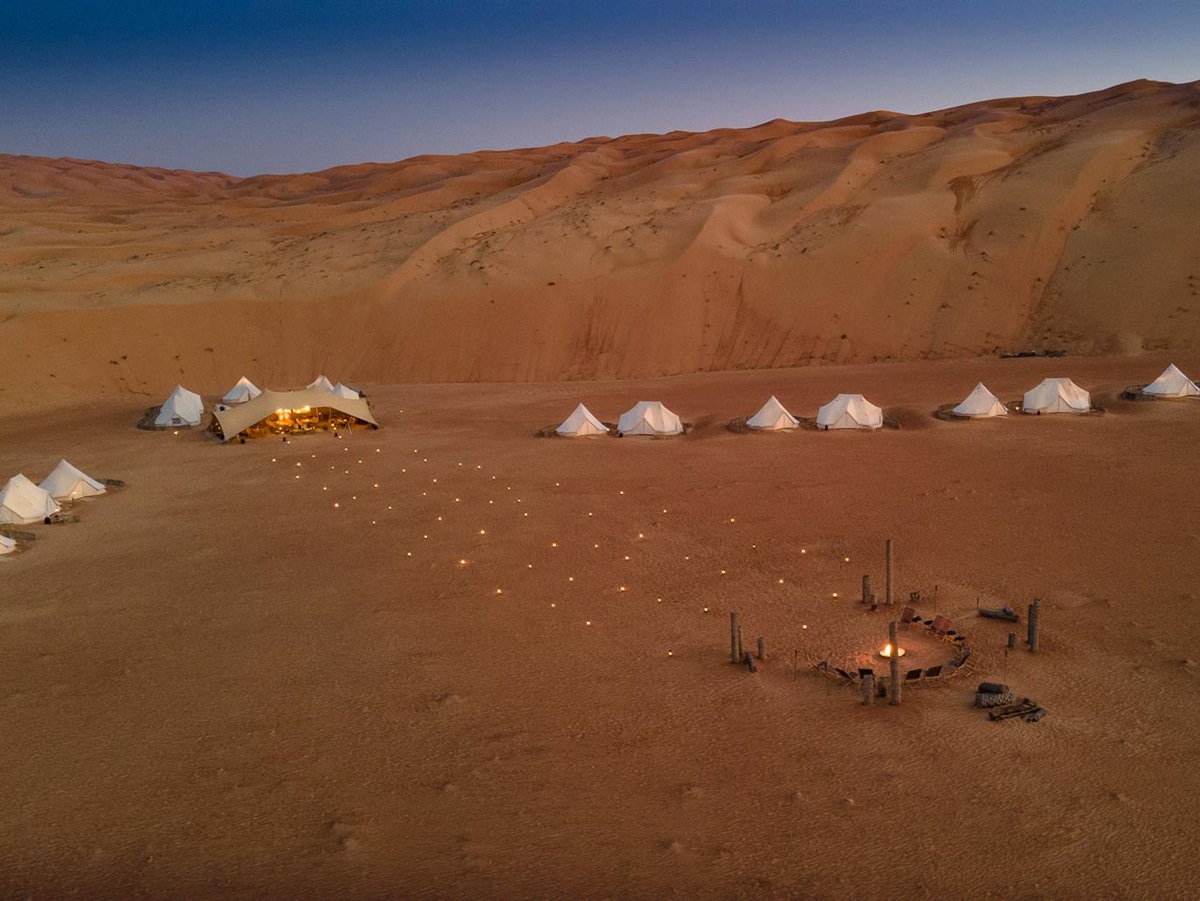 Exterior view of tents and firepit at Magic Camps Wahiba Sands in the Sharqiya Sands in Oman
