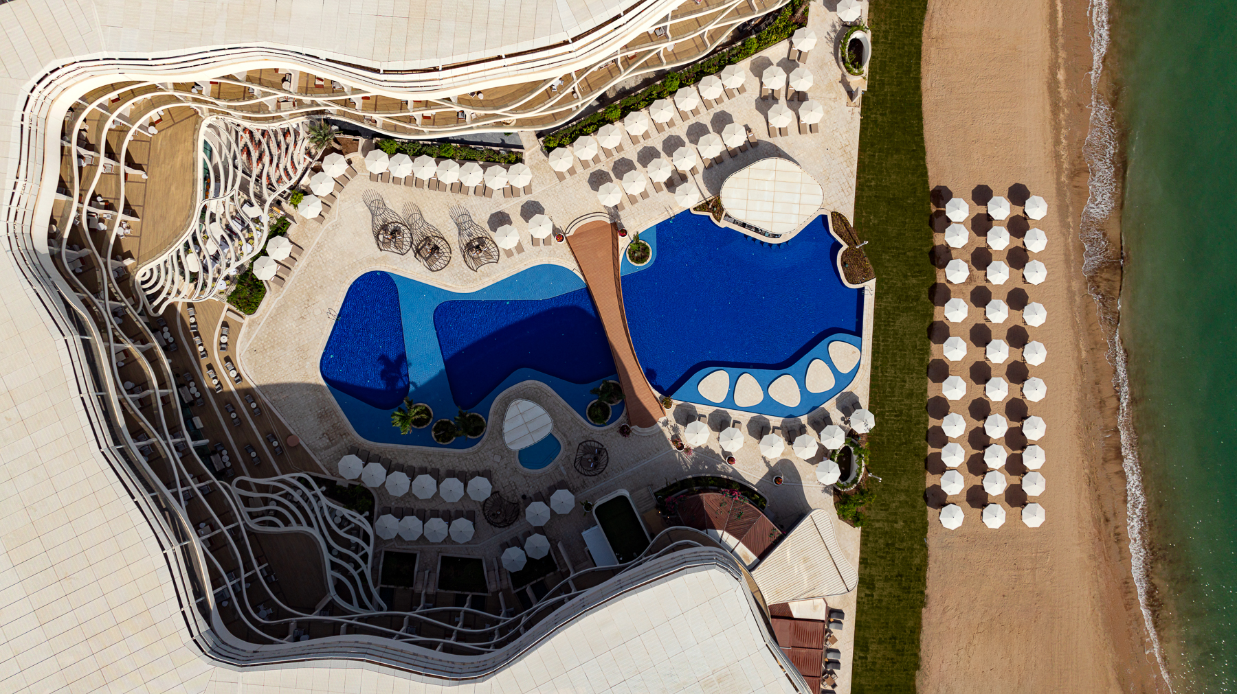 Aerial view of the swimming pool at St Regis Al Mouj Muscat Resort in Oman