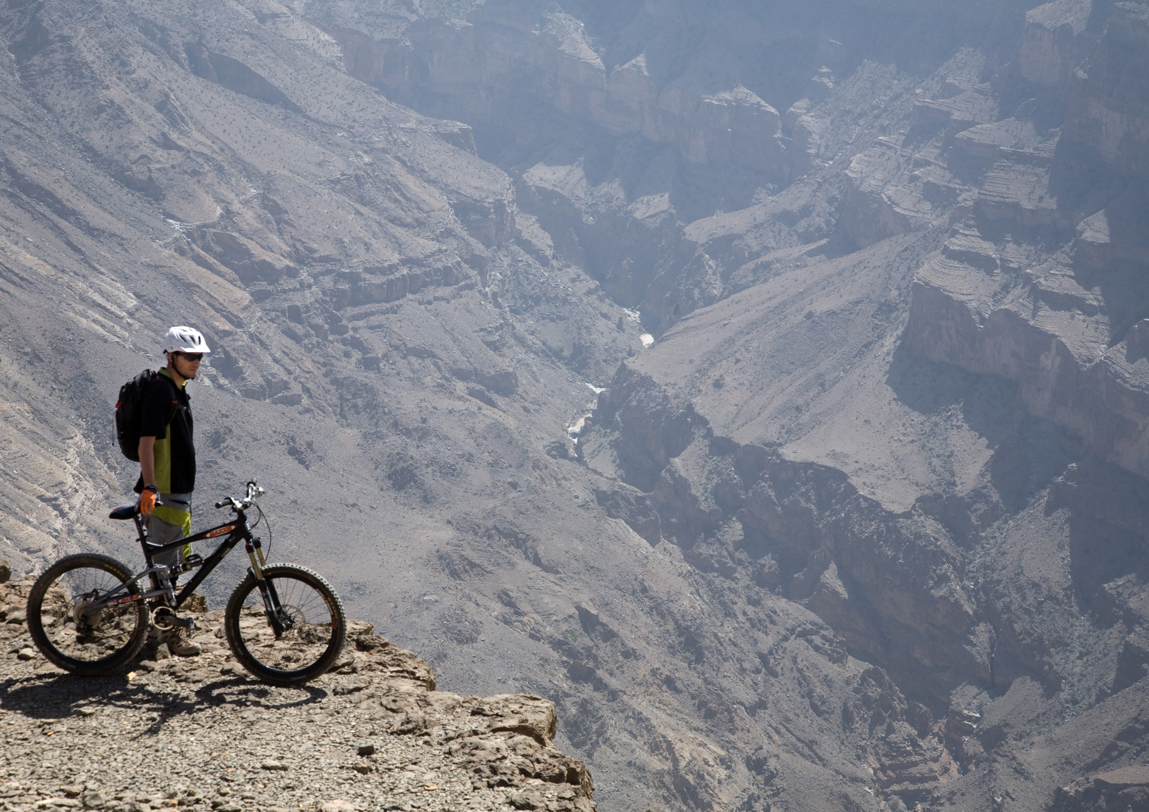 A biker overlooking a canyon near The View, Oman
