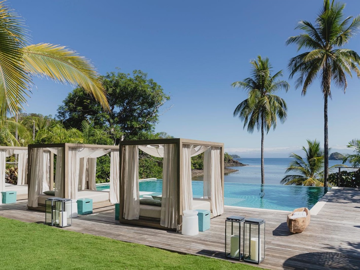 Poolside sunbeds with ocean views at Islas Secas resort in Panama