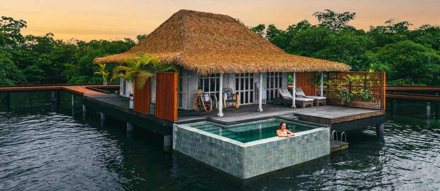 Exterior view of guest suite villa at sunset at Nayara Bocas Del Toro resort in Panama