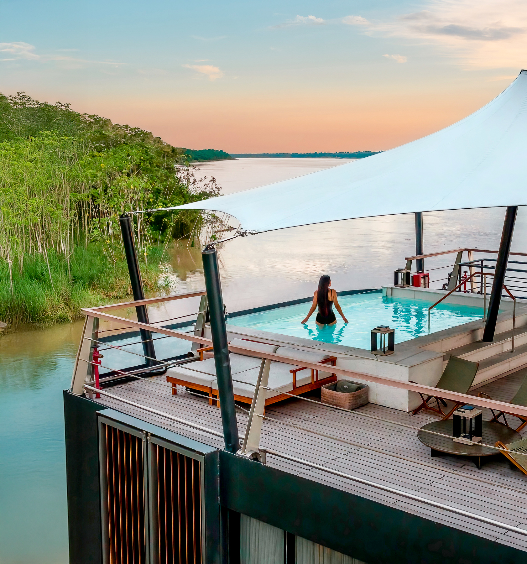 A woman in the swimming pool onboard the Aqua Nera luxury river cruiser on the Peruvian Amazon