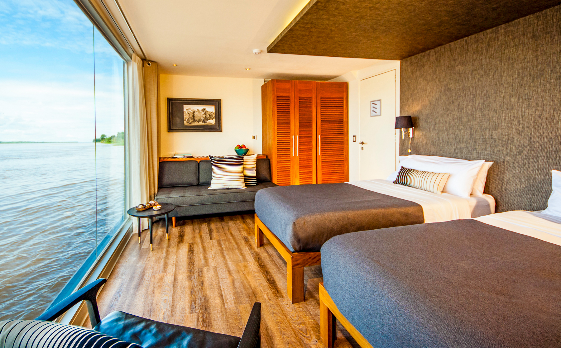 Design suite with twin beds onboard the Aria Amazon luxury river cruiser in Peru