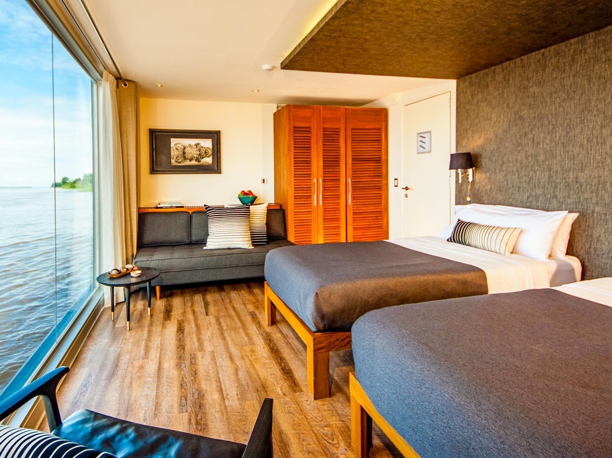 Design suite with twin beds onboard the Aria Amazon luxury river cruiser in Peru