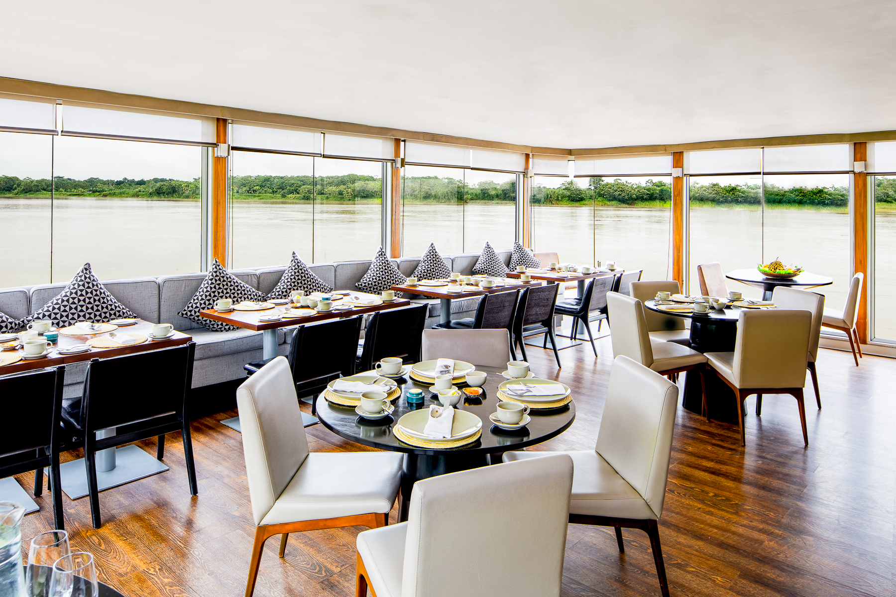 Dining tables onboard the Aria Amazon luxury river cruiser in Peru