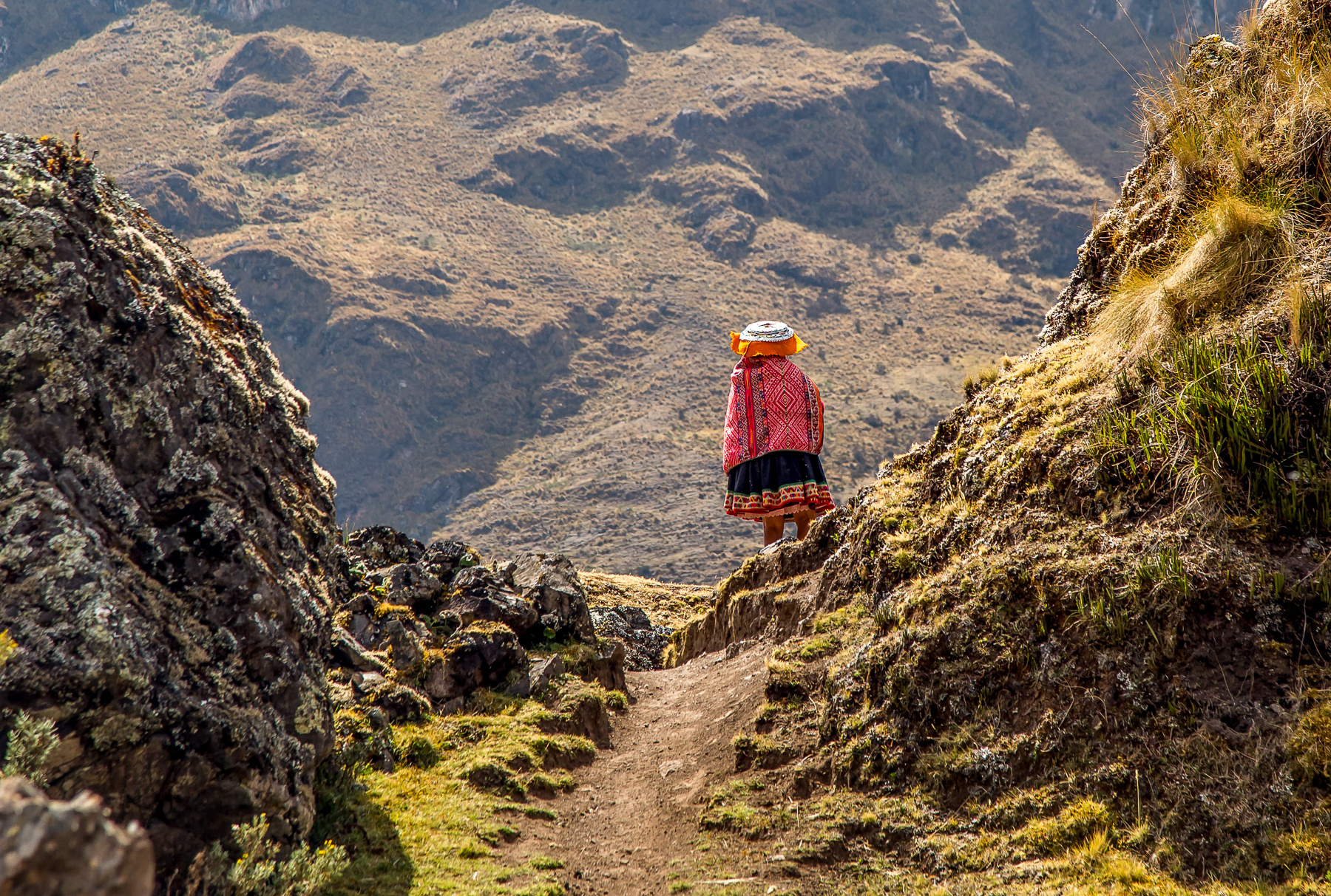 A local walking along a train near Explora Sacred Valley in Peru