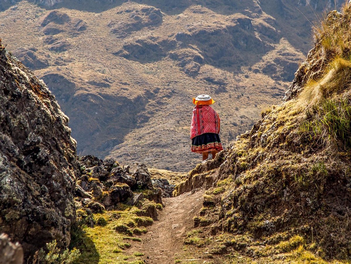 A local walking along a train near Explora Sacred Valley in Peru