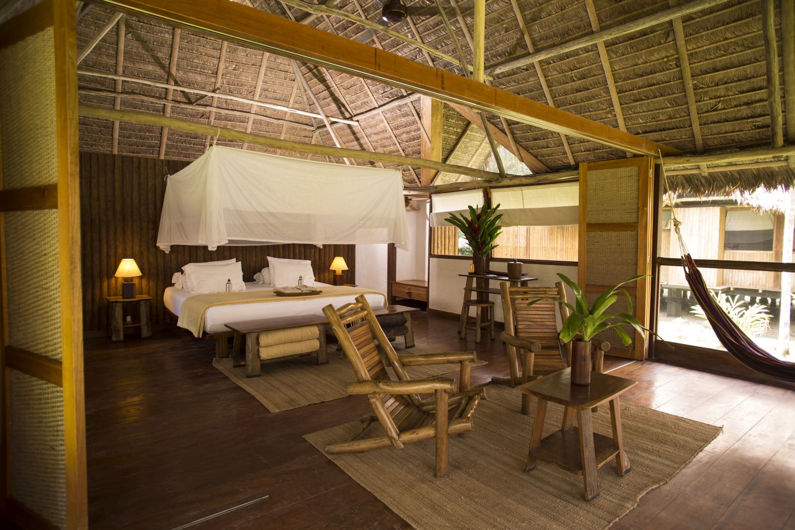 Bedroom and lounge area of the Amazonica Suite at Inkaterra Reserva Amazonica in Peru