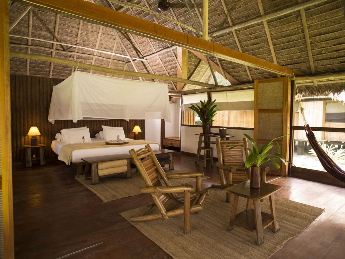 Bedroom and lounge area of the Amazonica Suite at Inkaterra Reserva Amazonica in Peru