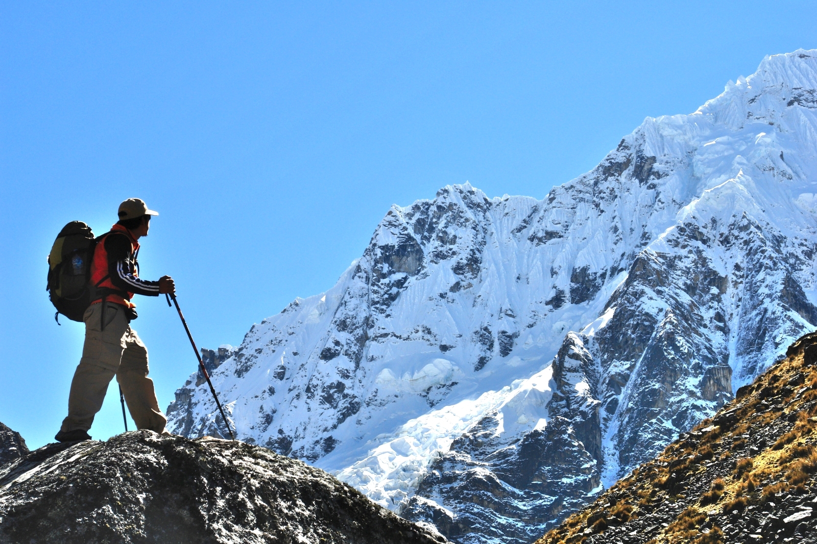 Hiker looking at the snow-capped mountains in Peru