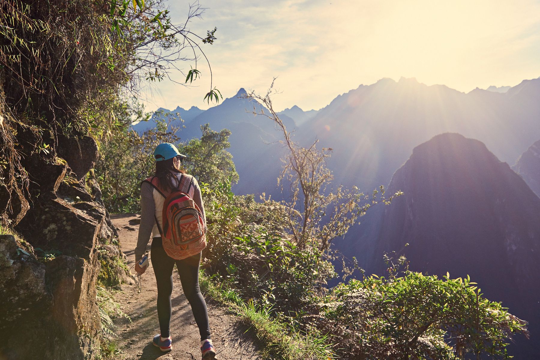 A woman hiking in Peru's Sacred Valley towards Machu Picchu