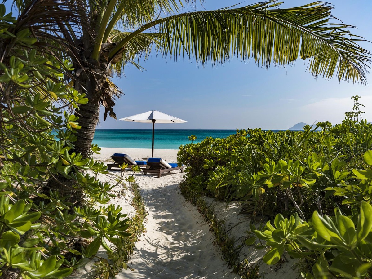 Beach loungers at Amanpulo luxury beach resort in the Philippines