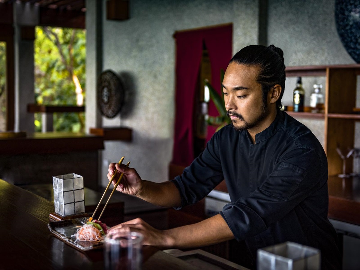 A chef preparing cuisine at Amanpulo luxury beach resort in the Philippines