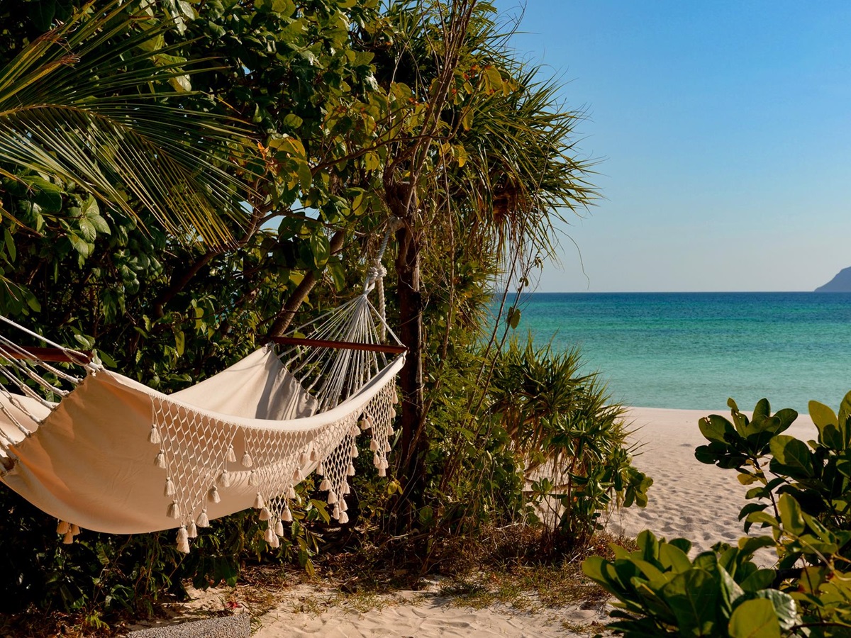 A hammock on the beach at Amanpulo luxury beach resort in the Philippines