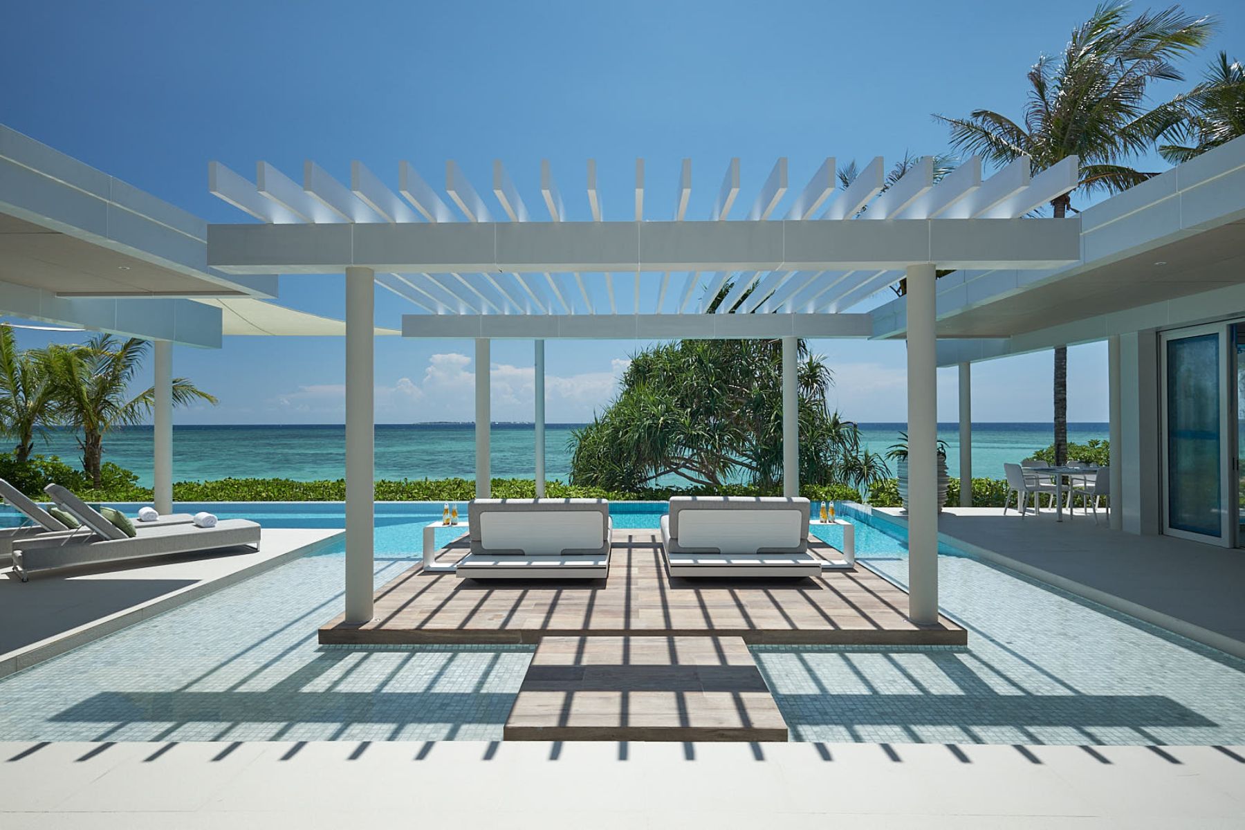 Sun loungers and pool of a villa at Banwa Private Island Philippines