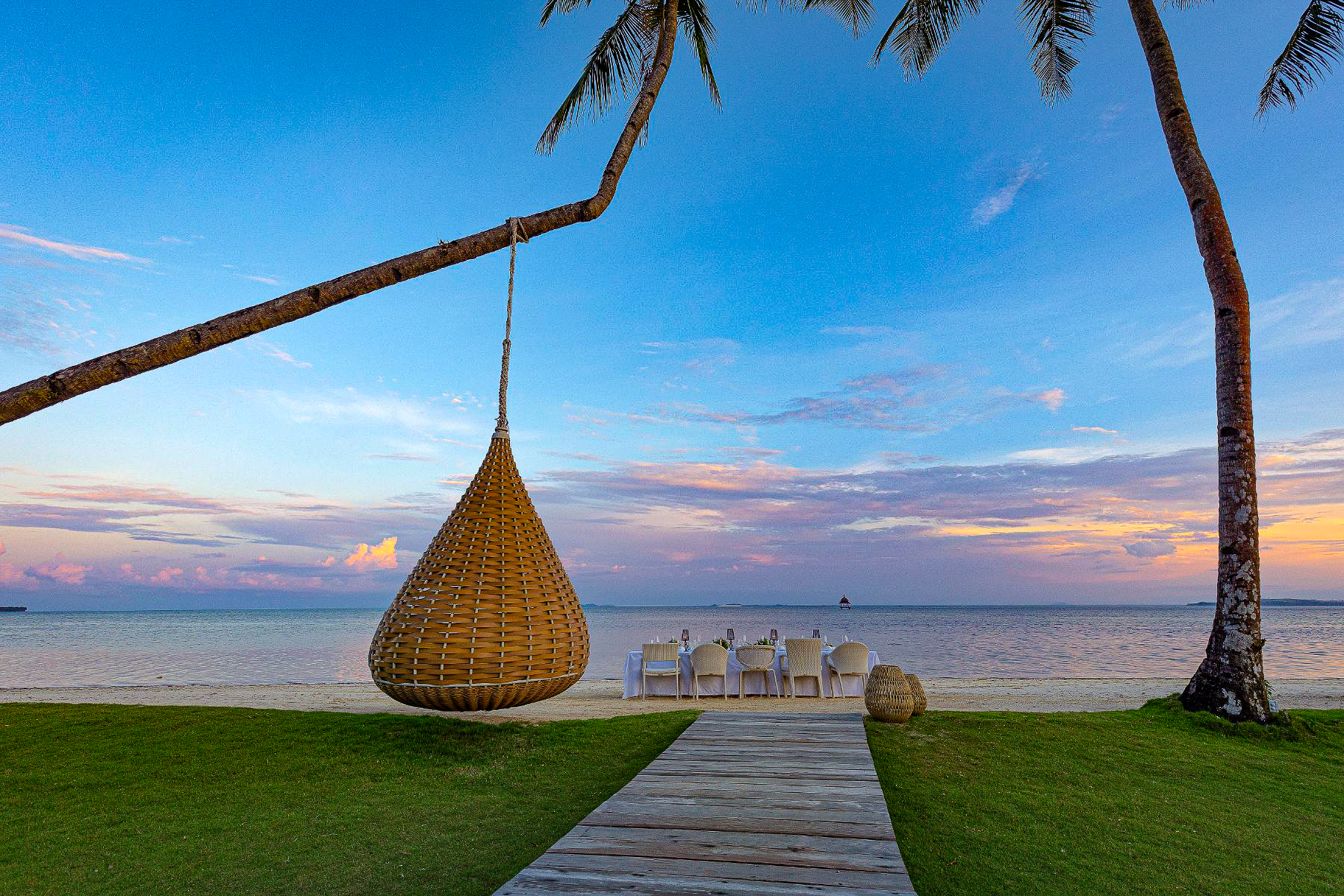 Evening dinner setup on the beach at Nay Palad Hideaway beach resort in the Philippines
