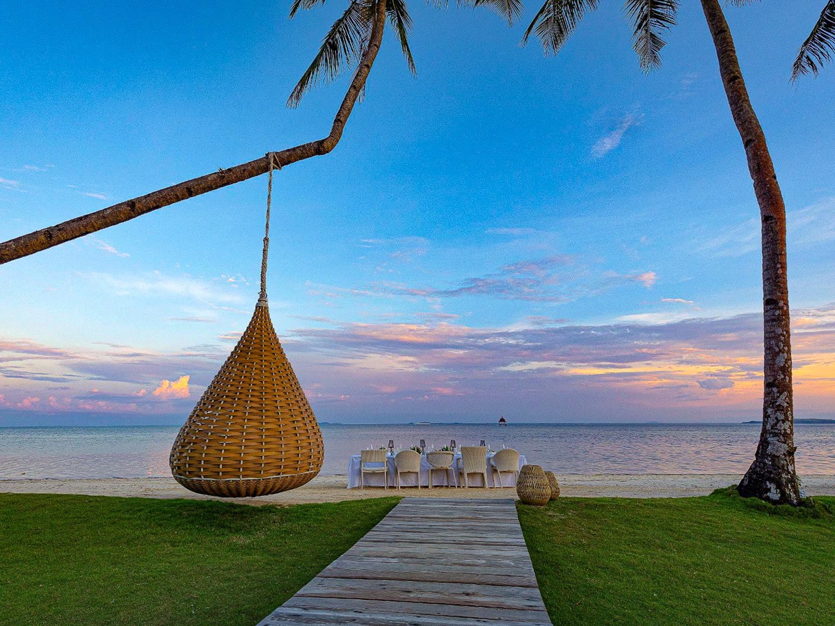 Evening dinner setup on the beach at Nay Palad Hideaway beach resort in the Philippines