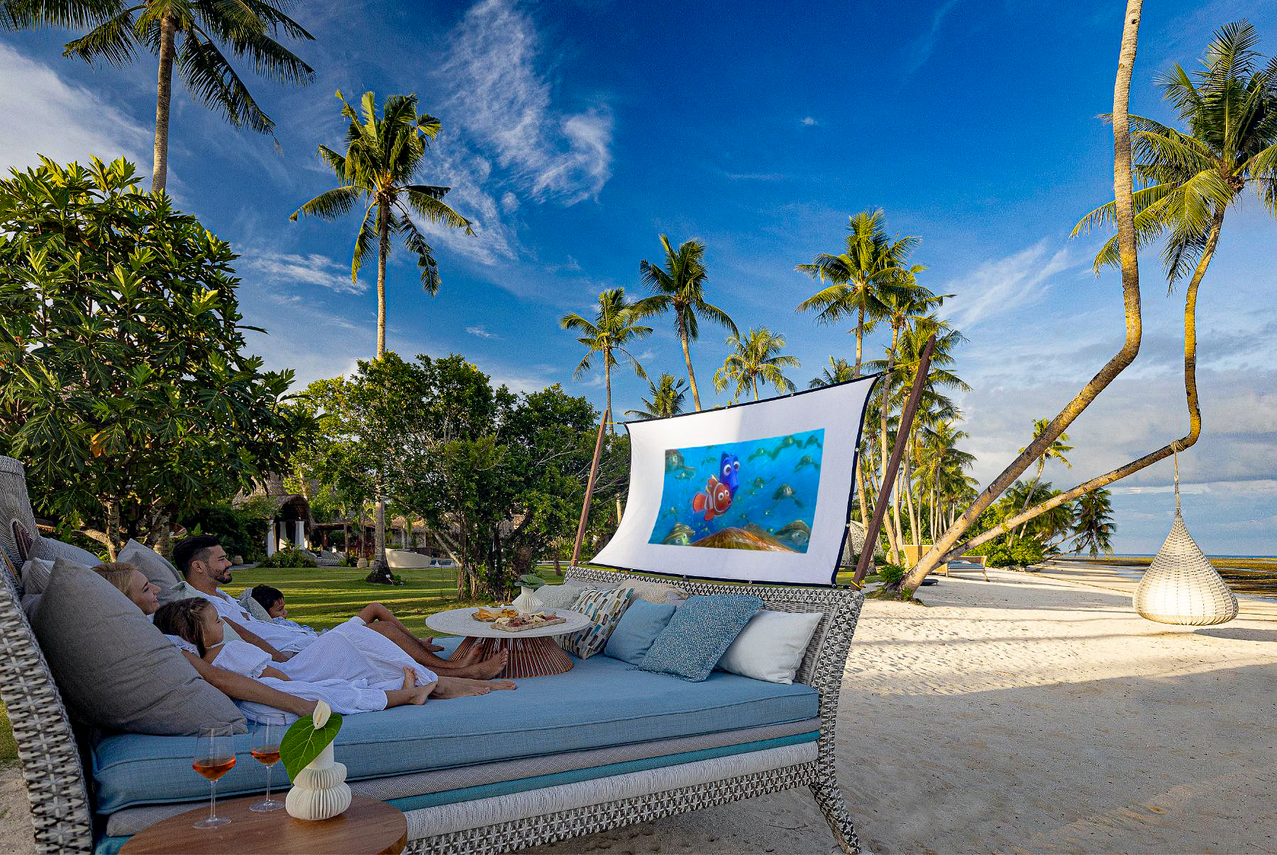 A family watching a film at the outdoor cinema at Nay Palad Hideaway beach resort in the Philippines