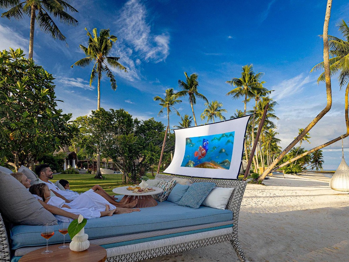 A family watching a film at the outdoor cinema at Nay Palad Hideaway beach resort in the Philippines