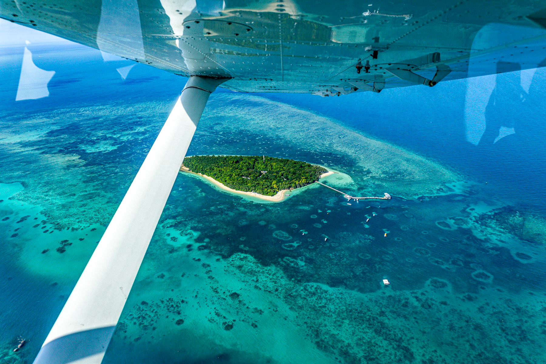 An aeroplane flying over a tropical island in the Philippines