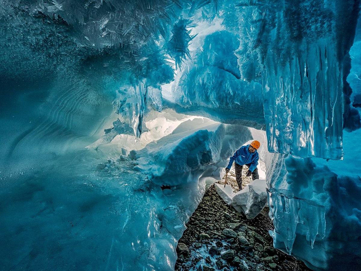 A man exploring an ice cave near Whichaway by White Desert in Antarctica