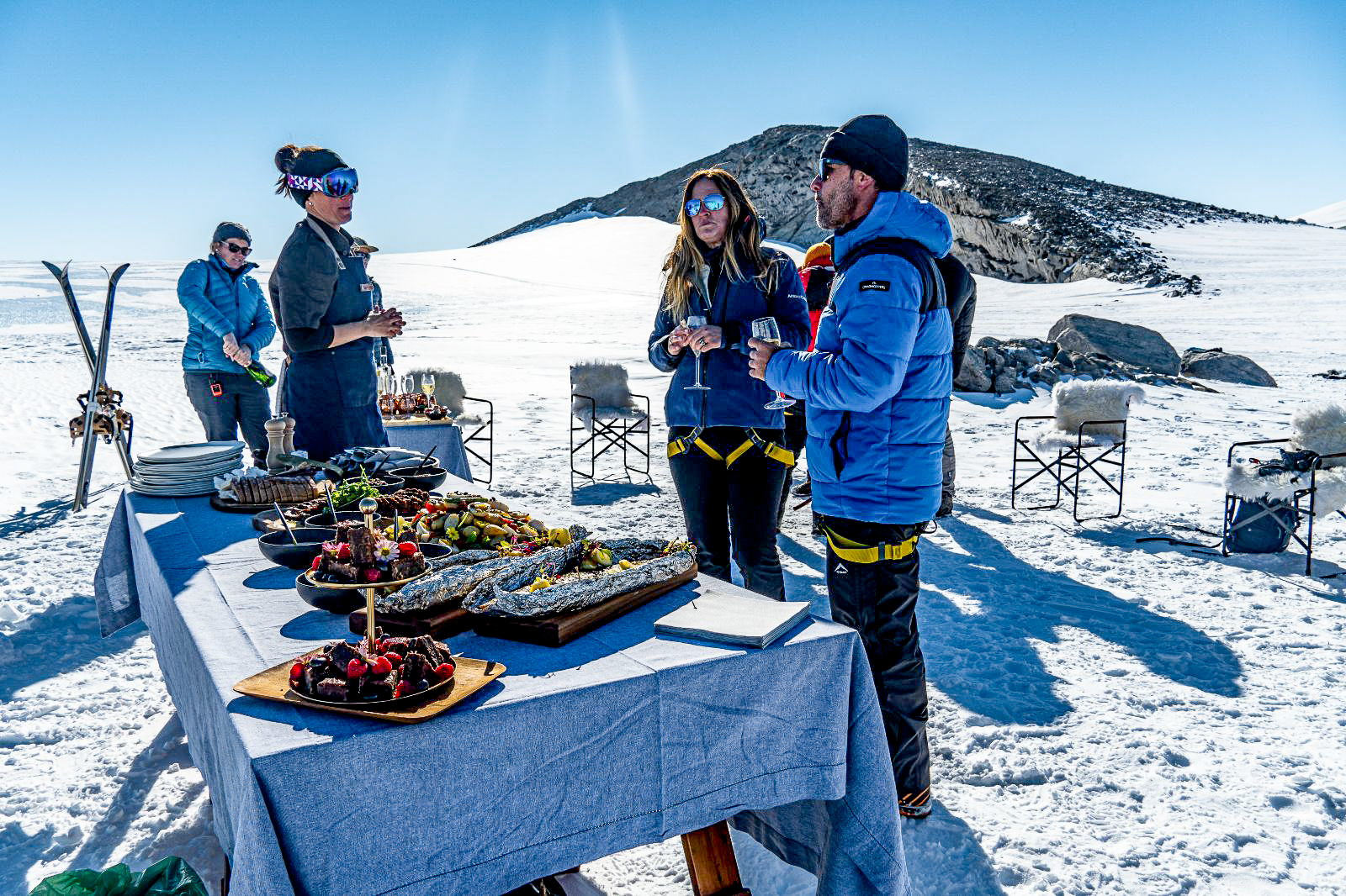 A guest picnic atop a cliff in Antarctica near Whichaway camp by White Desert