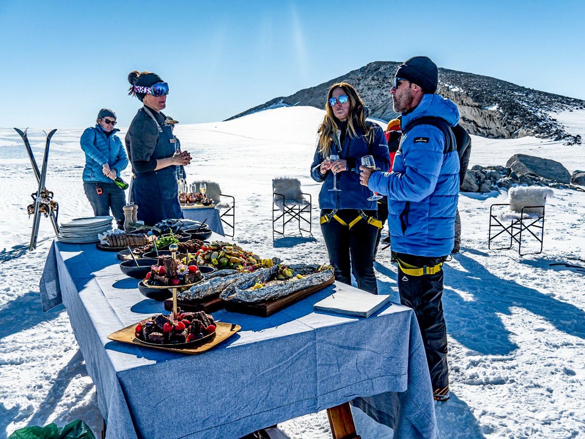 A guest picnic atop a cliff in Antarctica near Whichaway camp by White Desert