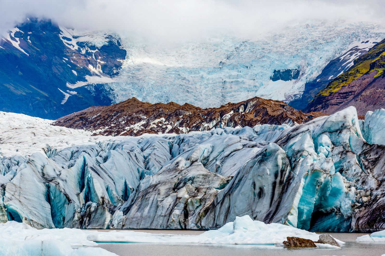 A glacier set against mountains in the Arctic