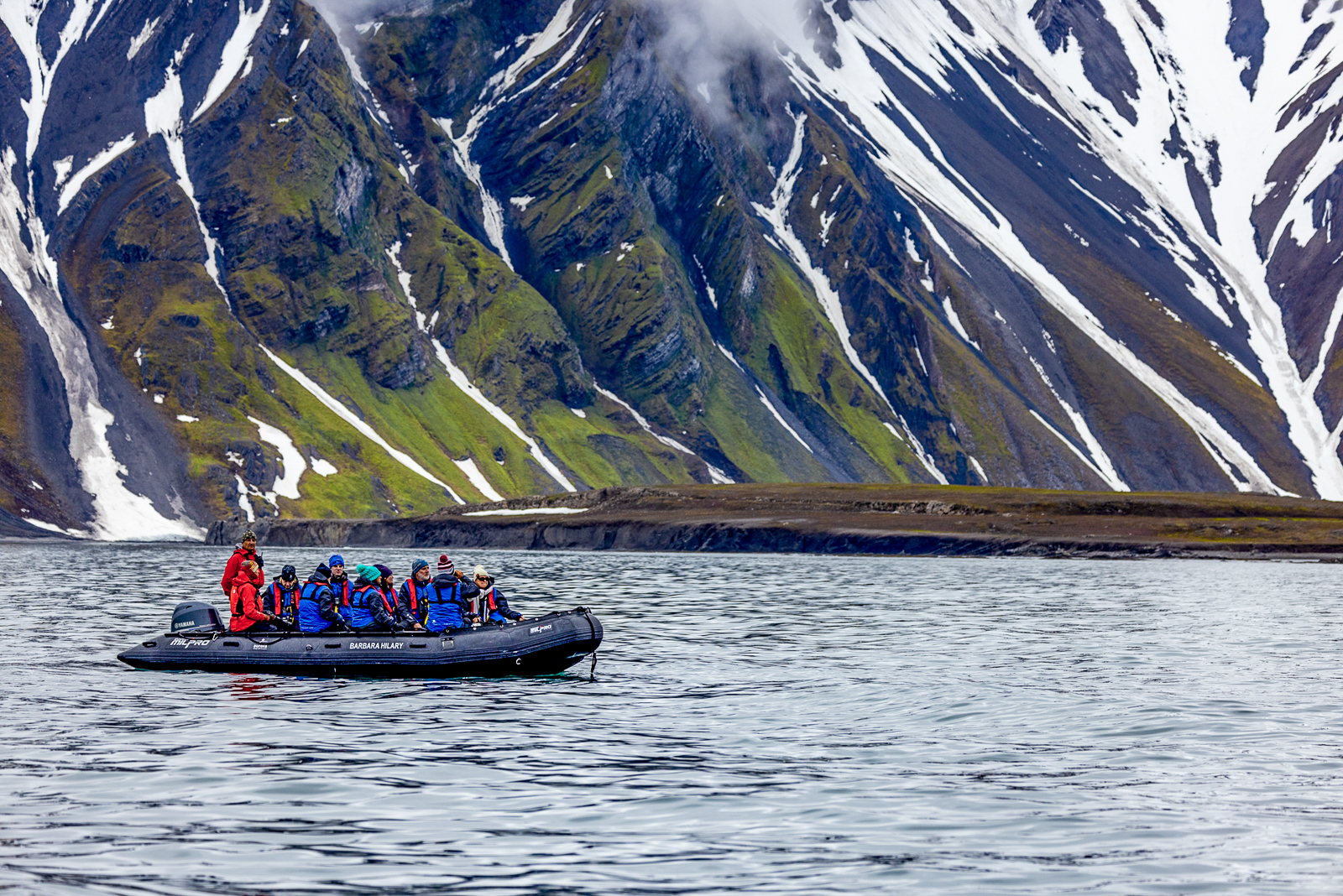 Guests of Aurora Expeditions' Sylvia Earle cruise ship on a zodiac safari in the Arctic