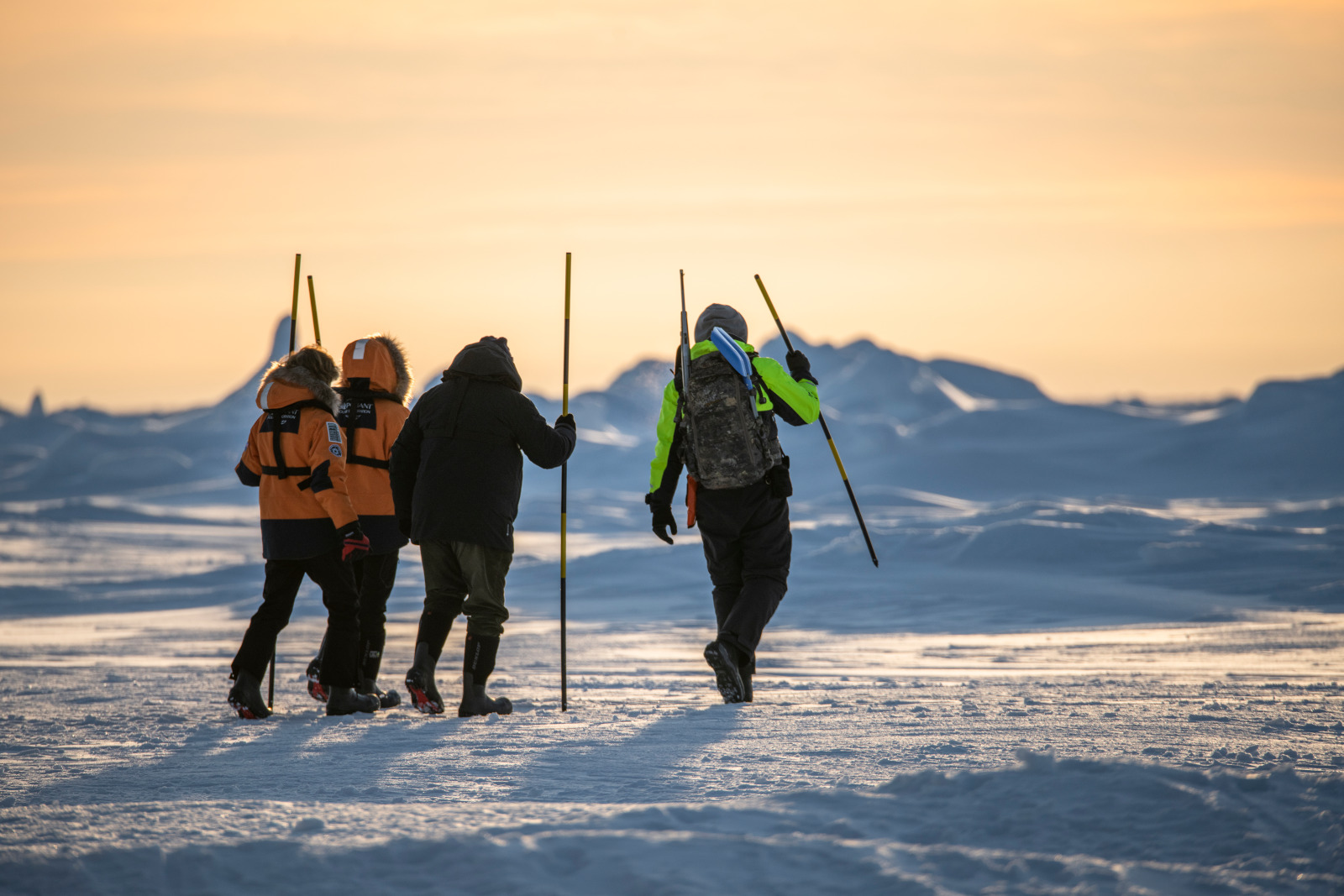 Guests of a Ponant Arctic cruise trekking on the ice