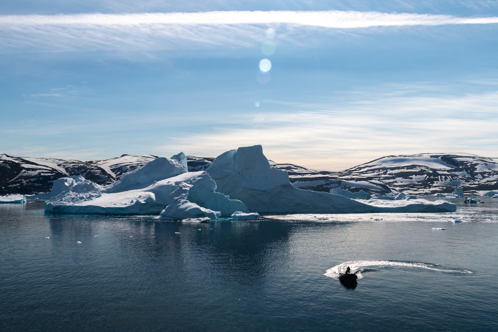 A Zodiac on safari near icebergs in Arctic waters