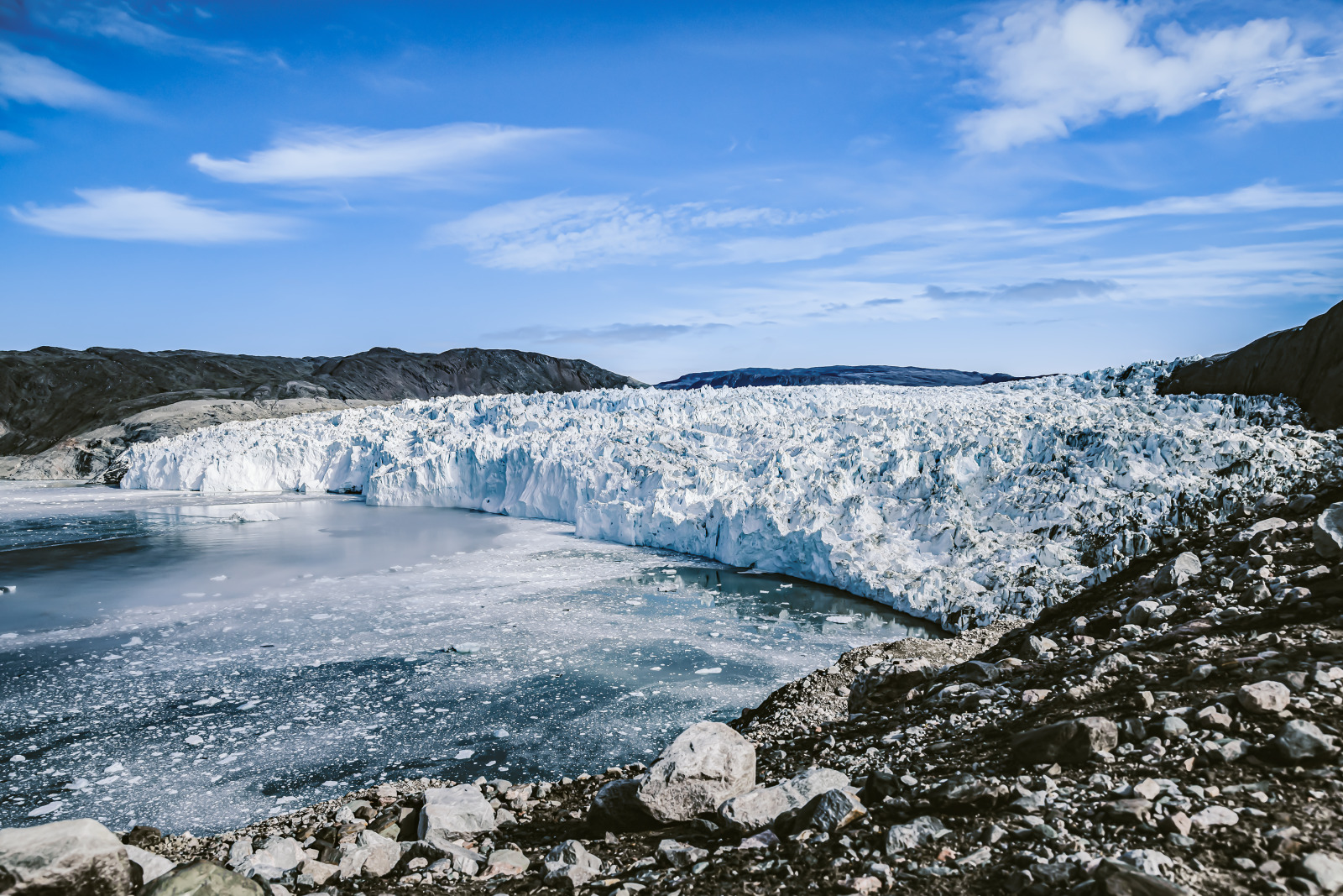 Icy water and a colossal glacier face in Arctic Greenland