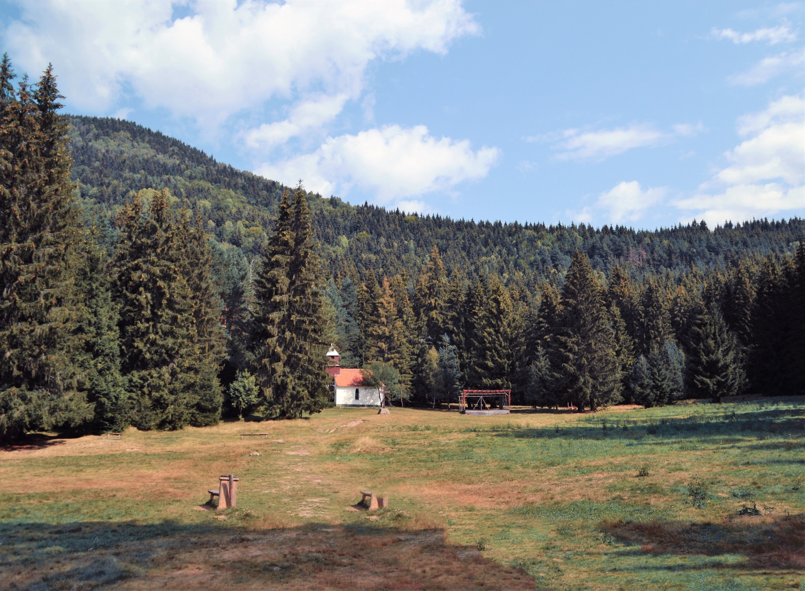Open field with small wooden building in Maramures in Romania